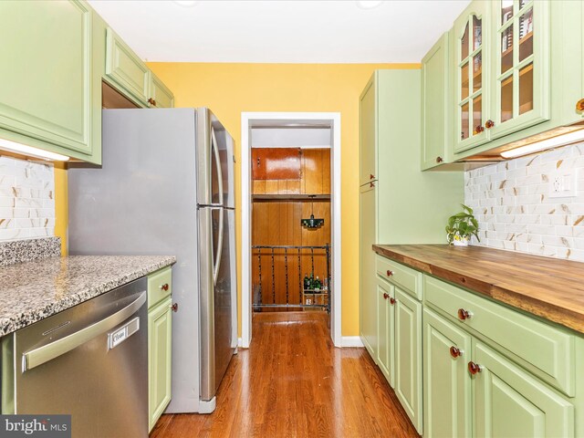 kitchen featuring butcher block countertops, appliances with stainless steel finishes, and green cabinets