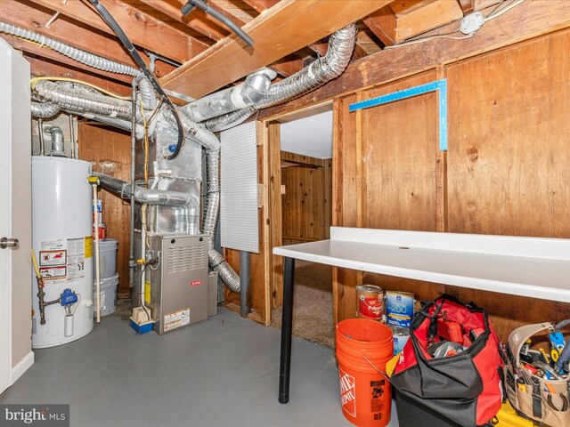 unfinished basement with heating unit and water heater