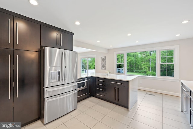 kitchen with light countertops, appliances with stainless steel finishes, light tile patterned floors, and recessed lighting