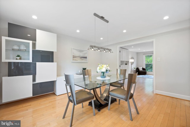 dining area with recessed lighting, baseboards, and light wood finished floors