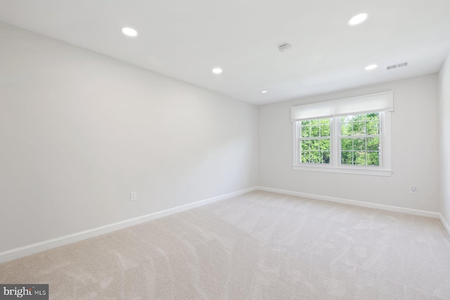 carpeted spare room featuring baseboards, recessed lighting, and visible vents