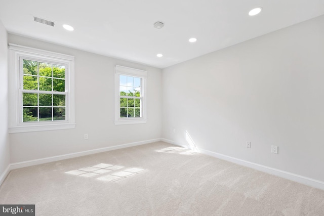 carpeted spare room with visible vents, recessed lighting, and baseboards