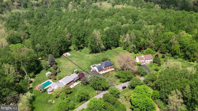 birds eye view of property with a forest view