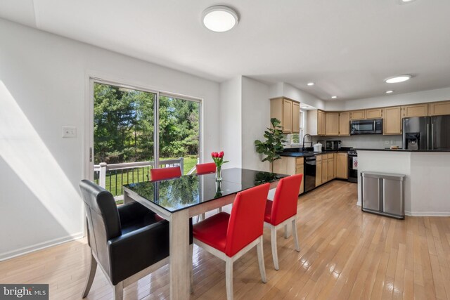 dining room with light wood-type flooring, recessed lighting, and baseboards