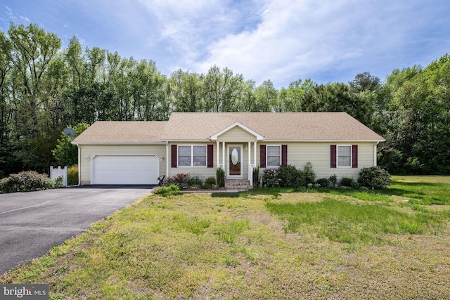 ranch-style home with a front lawn, driveway, and an attached garage