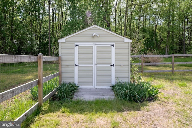 view of shed featuring fence