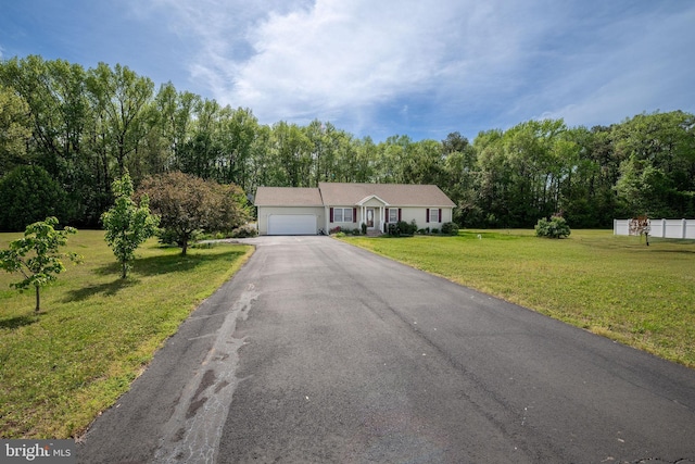 ranch-style house with a front yard, driveway, and a garage