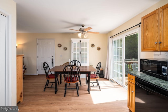dining area featuring ceiling fan and light wood-style flooring