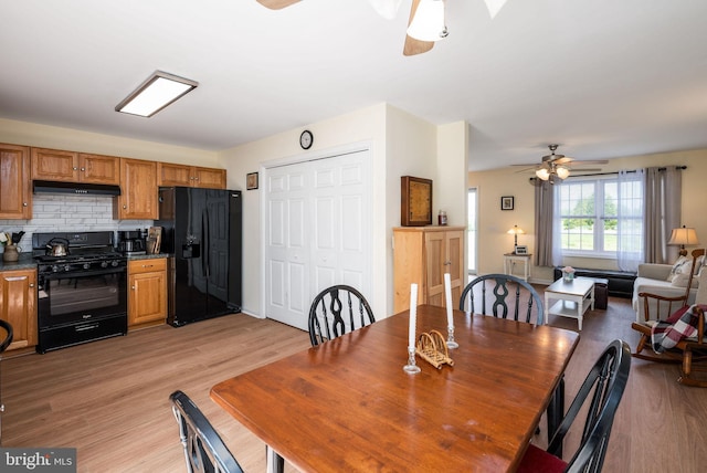 dining space with ceiling fan and light wood-style floors