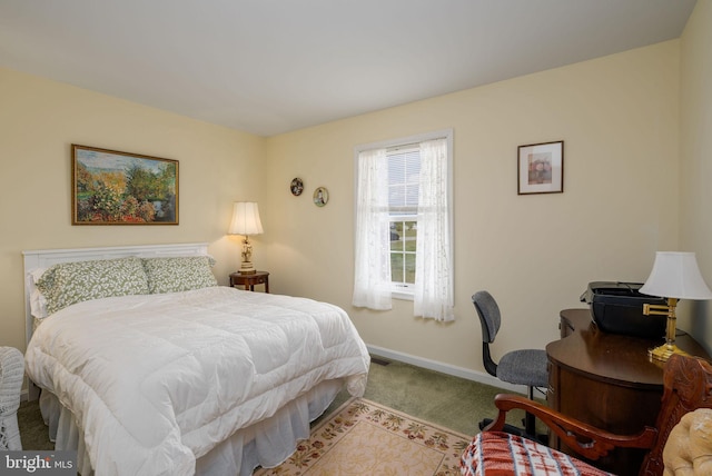 bedroom with carpet flooring and baseboards