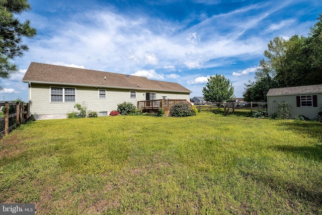 back of house featuring a deck, a fenced backyard, and a yard