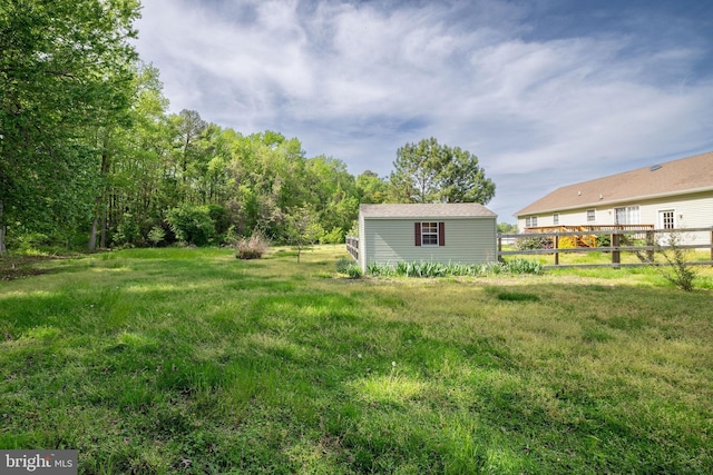 view of yard featuring fence and an outdoor structure