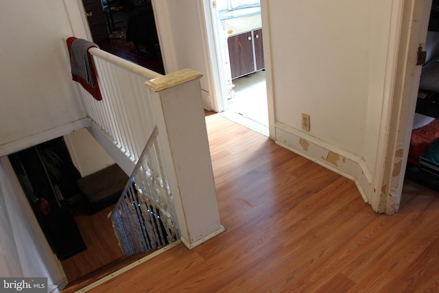 staircase featuring wood finished floors