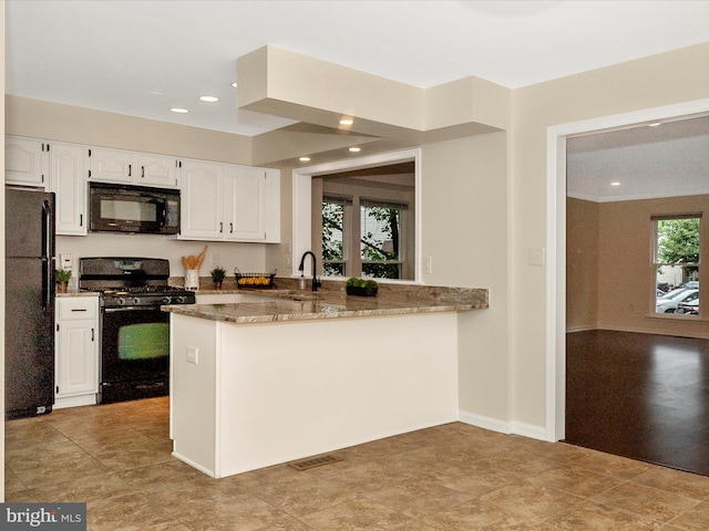 20216 Tidewinds Way, Germantown, MD 20874 - kitchen featuring black appliances, stone countertops, white cabinetry, recessed lighting, and a sink