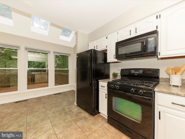 20216 Tidewinds Way, Germantown, MD 20874 - kitchen with black appliances, a skylight, white cabinets, and plenty of natural light