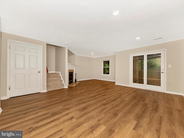 20216 Tidewinds Way, Germantown, MD 20874 - unfurnished living room with light wood-style flooring, baseboards, a fireplace with flush hearth, recessed lighting, and stairway