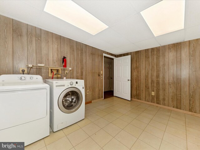 20216 Tidewinds Way, Germantown, MD 20874 - laundry area with washing machine and clothes dryer, wood walls, light tile patterned floors, and baseboards