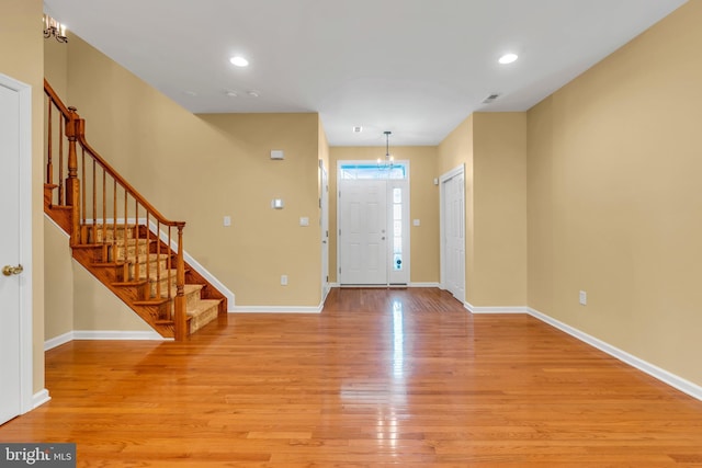 foyer featuring recessed lighting, baseboards, stairway, and light wood-type flooring