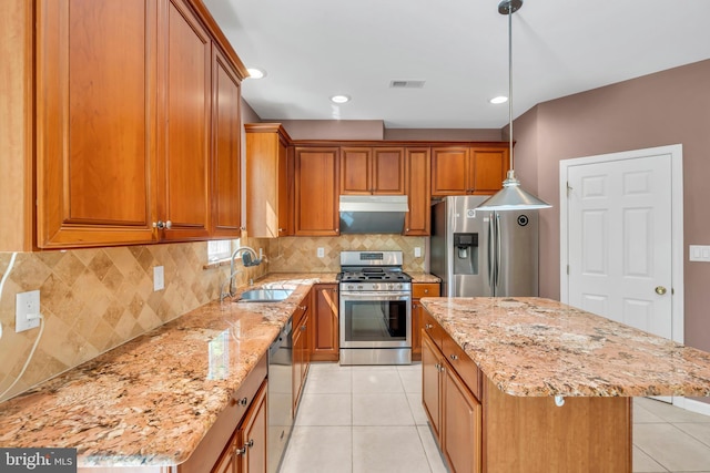 kitchen with visible vents, brown cabinets, light tile patterned flooring, and stainless steel appliances