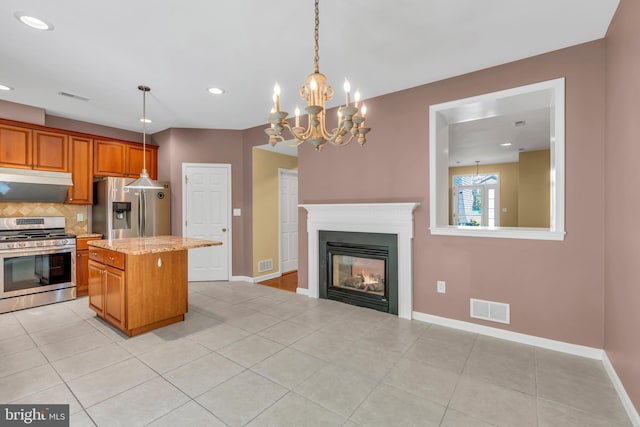 kitchen with visible vents, decorative backsplash, appliances with stainless steel finishes, and a kitchen island
