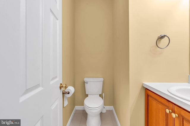 bathroom with vanity, tile patterned flooring, baseboards, and toilet