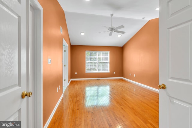 unfurnished room with light wood finished floors, a ceiling fan, baseboards, recessed lighting, and lofted ceiling