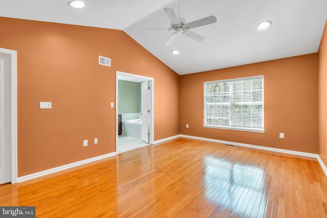 unfurnished bedroom featuring visible vents, baseboards, light wood-style floors, and lofted ceiling