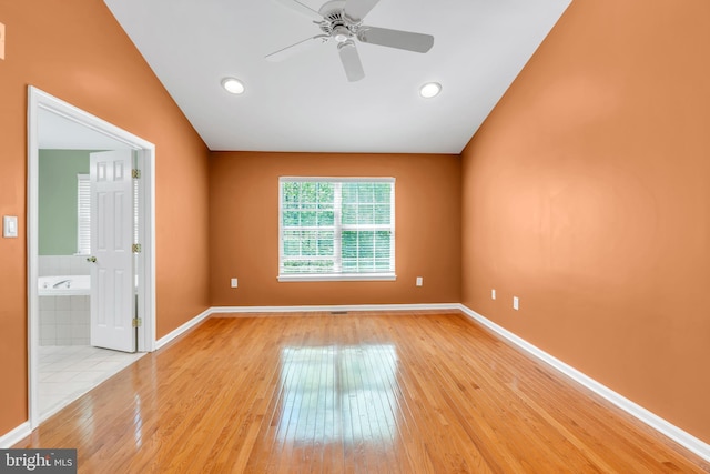 empty room featuring light wood finished floors, a ceiling fan, baseboards, recessed lighting, and vaulted ceiling