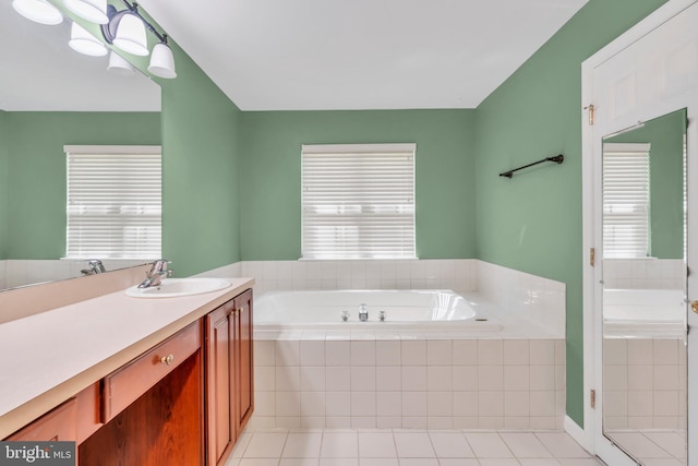 bathroom with vanity, tile patterned floors, and a bath