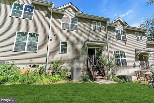 back of property with a yard, central AC, and entry steps