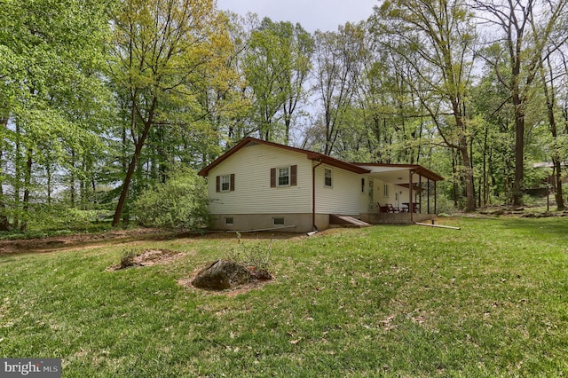 view of side of property with a yard