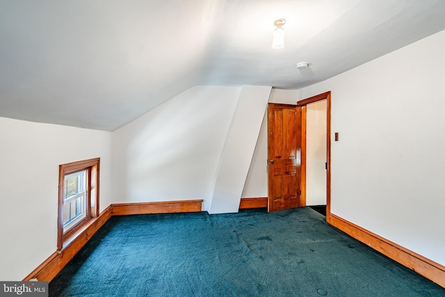 bonus room with vaulted ceiling, carpet, and baseboards