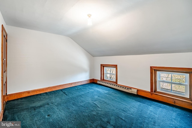 additional living space with lofted ceiling, carpet, baseboard heating, and baseboards