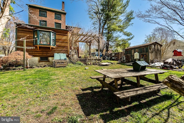 view of yard with an outbuilding and a storage shed
