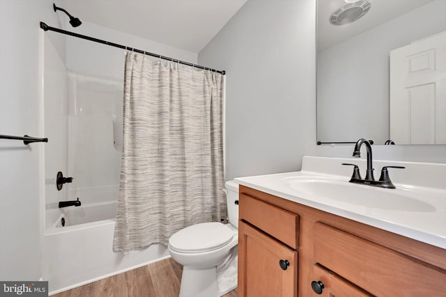 bathroom featuring wood finished floors, toilet, vanity, and shower / tub combo with curtain