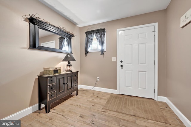 foyer with wood finished floors and baseboards