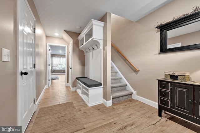 mudroom featuring baseboards, recessed lighting, and light wood-style flooring