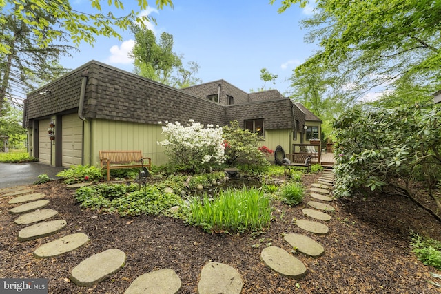4025 Branches Ln, Doylestown, PA 18902 - view of front of house featuring a garage, a deck, a shingled roof, and mansard roof