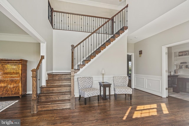 entrance foyer featuring stairs, wood finished floors, and a towering ceiling