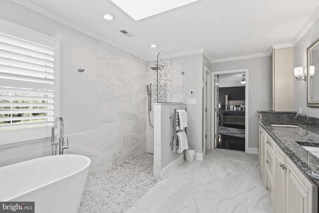 ensuite bathroom with marble finish floor, recessed lighting, a walk in shower, a freestanding bath, and a sink