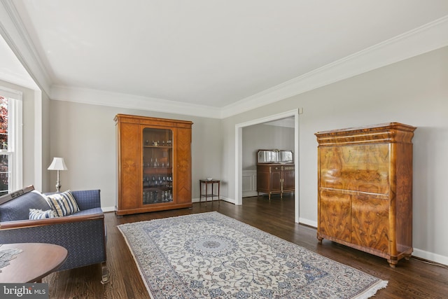living room with crown molding, baseboards, and dark wood-style floors