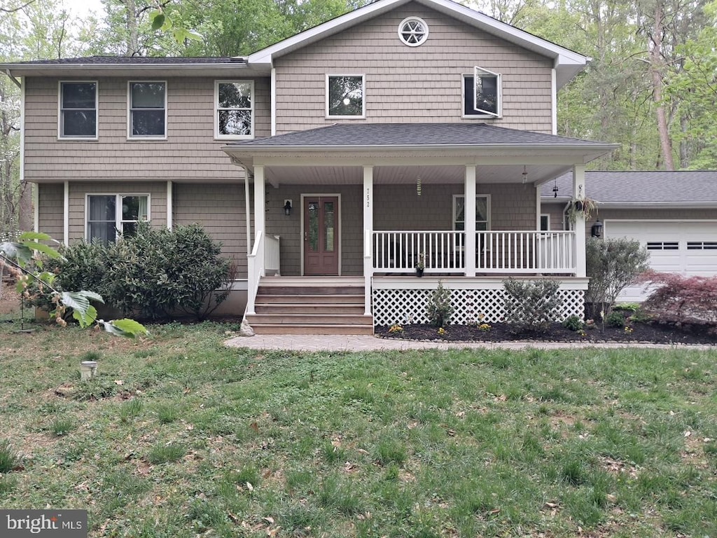 view of front of property with covered porch and a front lawn