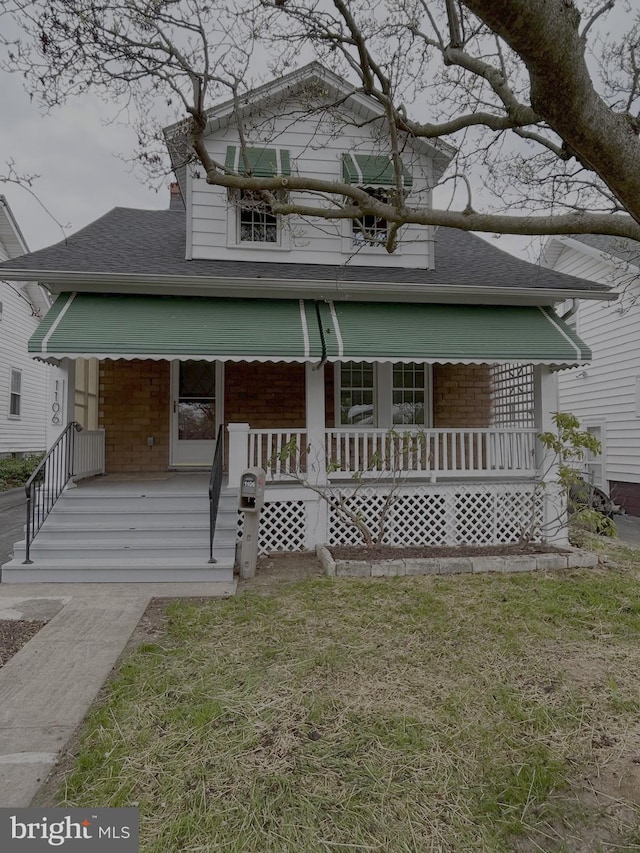 view of front of home featuring a porch and a shingled roof