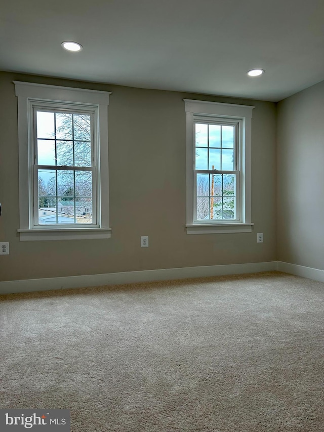 carpeted empty room with recessed lighting and baseboards