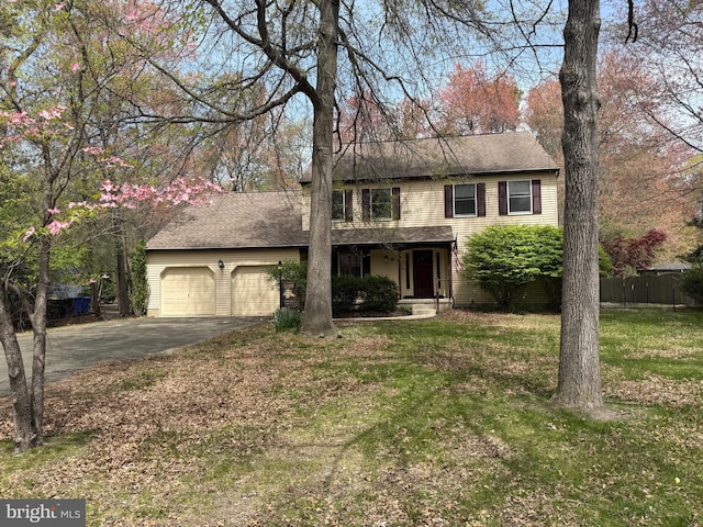 view of front of property with a front yard, driveway, a garage, and fence