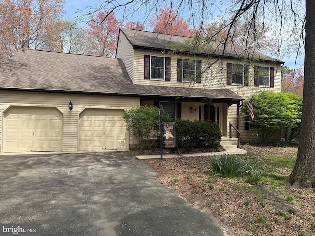 view of front of house with a porch, aphalt driveway, a shingled roof, and an attached garage