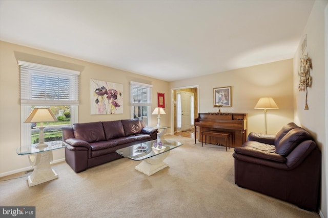 carpeted living area featuring baseboards and visible vents