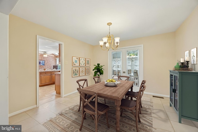 dining room featuring light tile patterned floors, a notable chandelier, baseboards, and visible vents