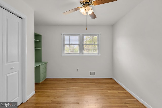 unfurnished dining area featuring baseboards, visible vents, ceiling fan, and light wood finished floors