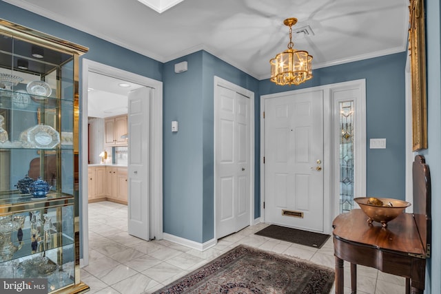 entryway with crown molding, baseboards, a chandelier, and visible vents